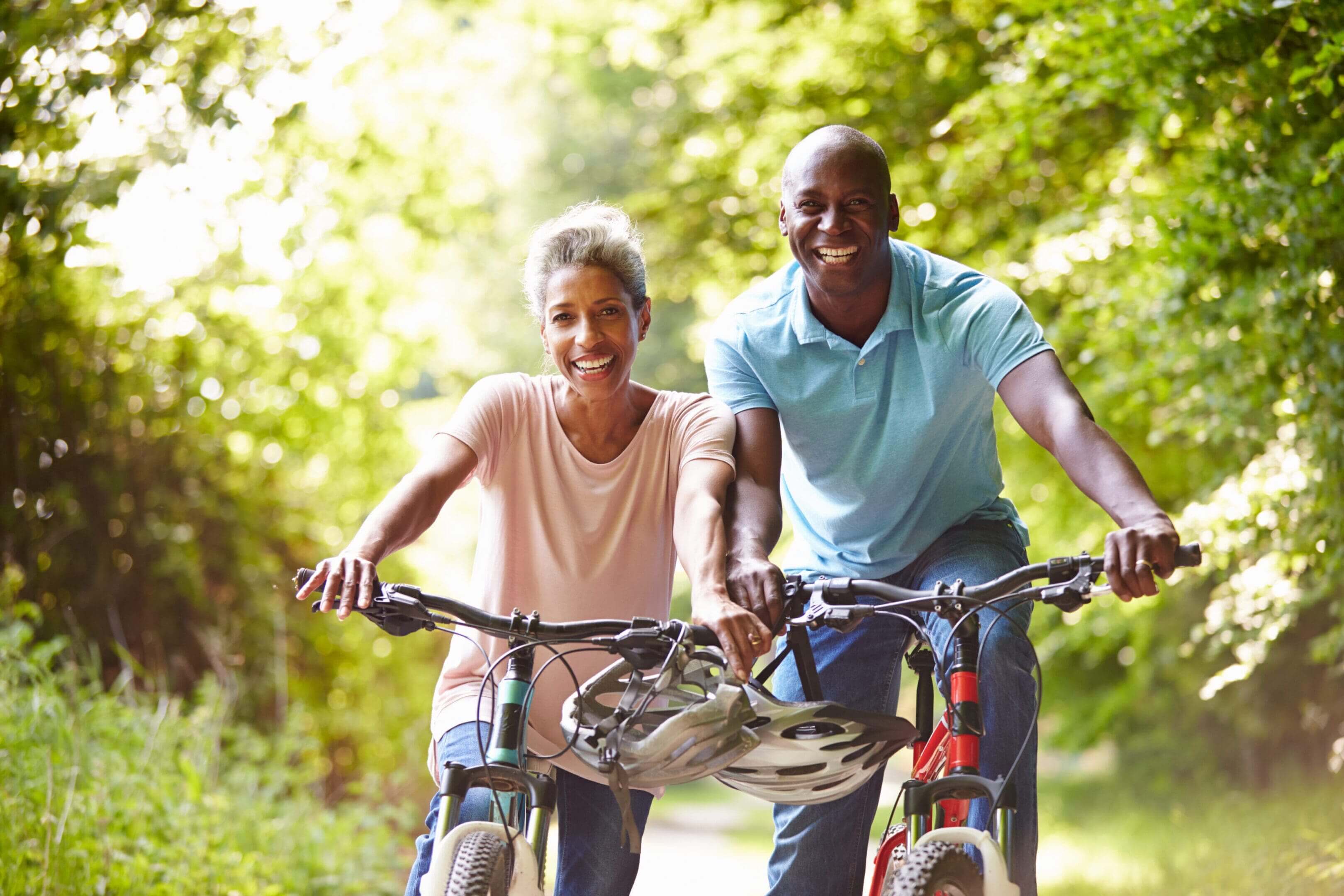 A man and woman riding bikes down the road.