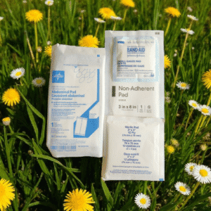 Medical pads on grass with yellow flowers.