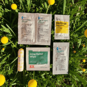 Medical supplies on grass with yellow flowers.